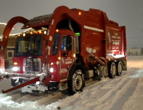 Image of Novak Sanitary truck driving in snow.