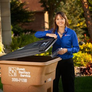 Image of Novak Sanitary employee by 96-gallon light brown recycling container.