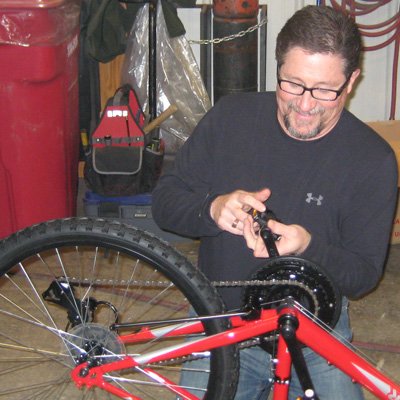 Novak Sanitary employee assembling bicycle for Sioux Falls Children's Home Society.