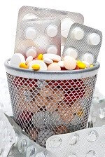 Image of miscellaneous pills and medications in trash.
